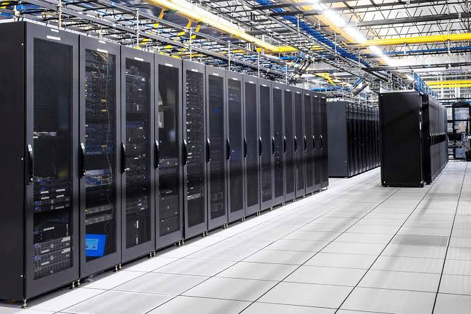Rows of server racks in a data center room.